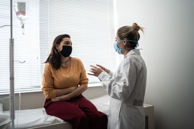 A woman consults with her gastroenterologist.