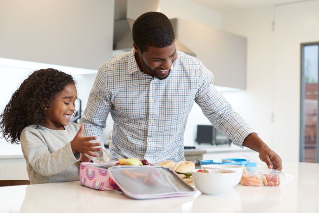 dad and daughter packing school lunch