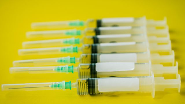 Vaccine syringes on yellow background. Meningitis vaccines are one vaccine recommended for teenagers.