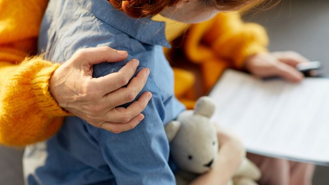 A child therapist counsels a young patient. 