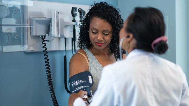Psoriasis patient getting blood pressure reading