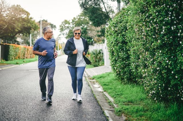 Healthy senior couple bonding while walking outdoors