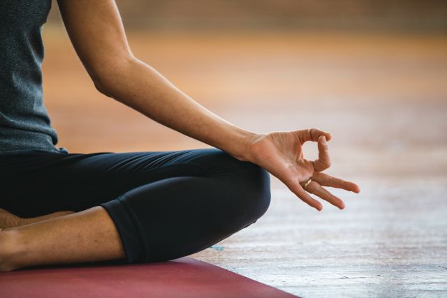 woman deep breathing and focusing on hands