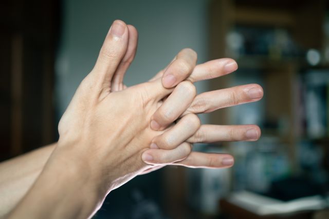 Closeup of a man's hands cracking knuckles