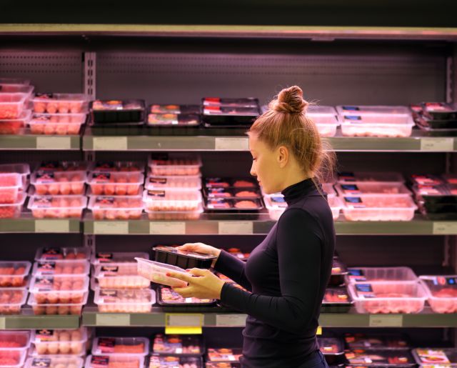 woman buying meat at the supermarket