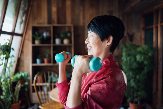 Active senior Asian woman using exercise and other COPD lifestyle changes, like healthy eating and weight loss.