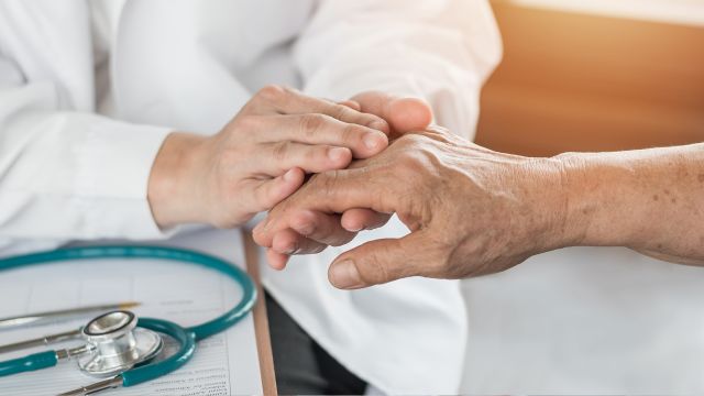 doctor examining patient's hand