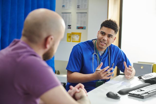 young medical professional doctor talking to patient