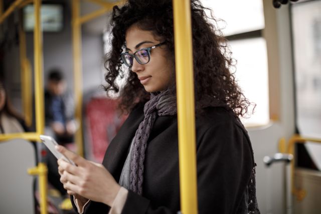 young woman on bus reading