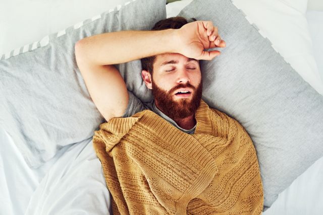 A young man snores while he sleeps as a result of sleep apnea