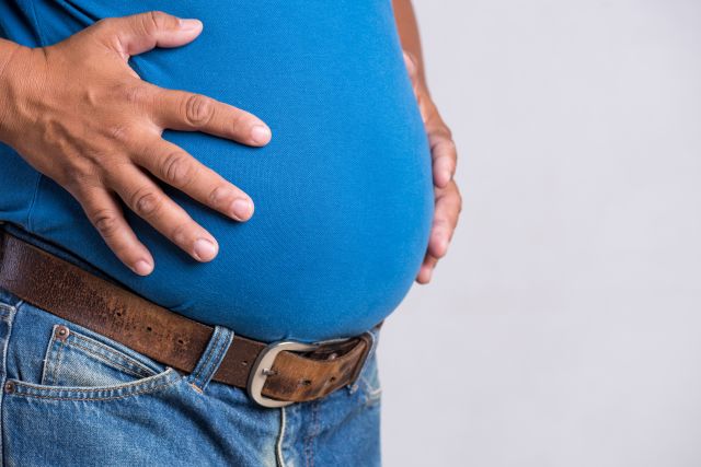 a close up of a man's beer belly, demonstrating a large amount of belly fat, or visceral fat