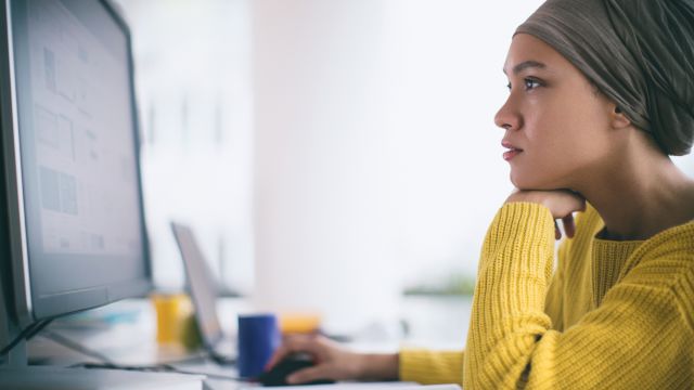 A breast cancer patient researches treatment options. HER2 status and hormone receptor status are important pieces of information when deciding on a treatment approach for breast cancer. 