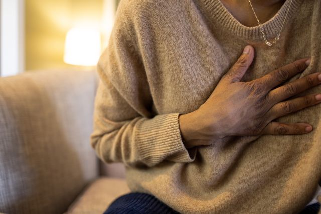 adult female experiencing chest pain