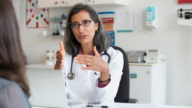 A female healthcare provider speaks with a new patient about treatment for indolent systemic mastocytosis.