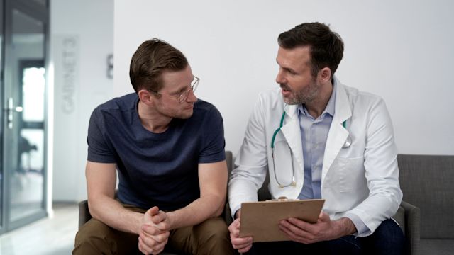 A middle-aged man talks to a primary care provider about the results of blood work. People living with depression are at increased risk of other health conditions, including cardiovascular disease and diabetes.