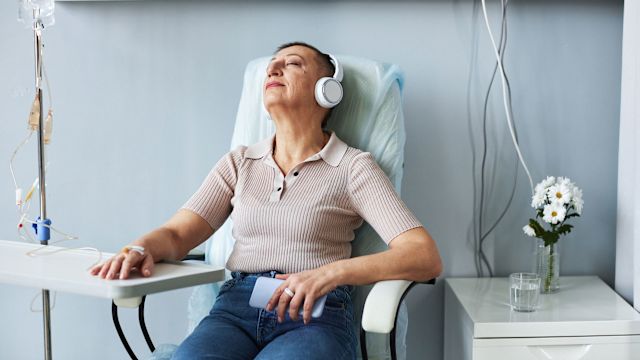 Mature woman with cancer receiving an immunotherapy treatment in a hospital