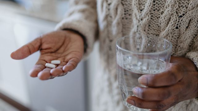 Senior man taking tablet medication for joint pain