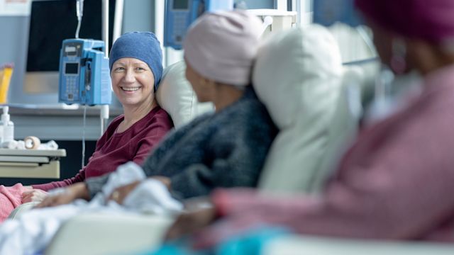 A group of women talk while receiving infusion therapy at an infusion center. Treatment for advanced endometrial cancer typically includes systemic therapies, such as chemotherapy, targeted therapy, and/or immunotherapy.