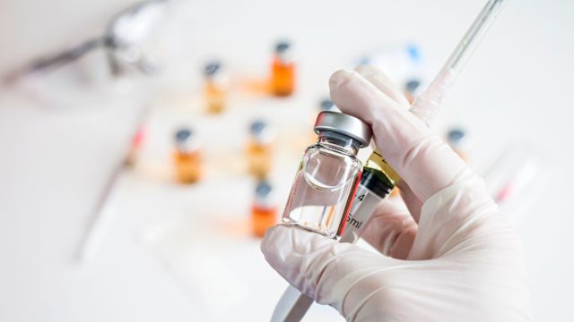 Closeup of gloved healthcare provider's hands as they prepare an infusion of a gene silencing therapy for ATTR-CM.