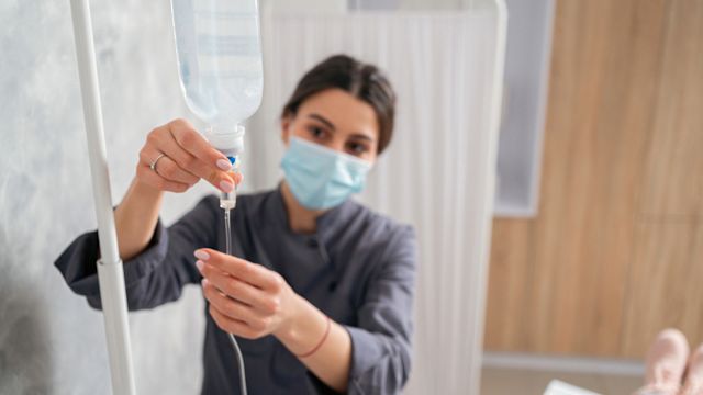 A healthcare worker prepares an infusion of intravenous immunoglobulin for a patient with primary immunodeficiency.