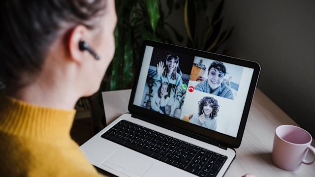 A young woman uses a laptop computer during an video call for an online support group for people living with primary immunodeficiency.