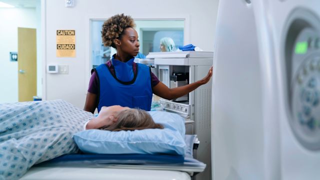 A healthcare provider begins an MRI for a senior woman who is living with early-stage Alzheimer's disease. MRI is recommended before beginning anti-amyloid therapy for Alzheimer's disease.