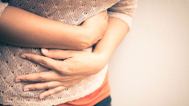 woman holding her stomach