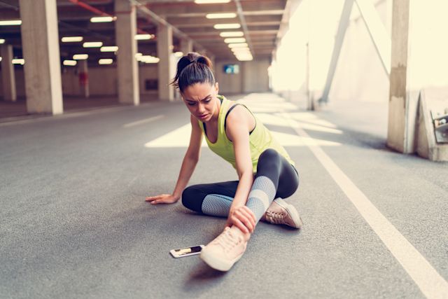young woman with ankle injury outdoors