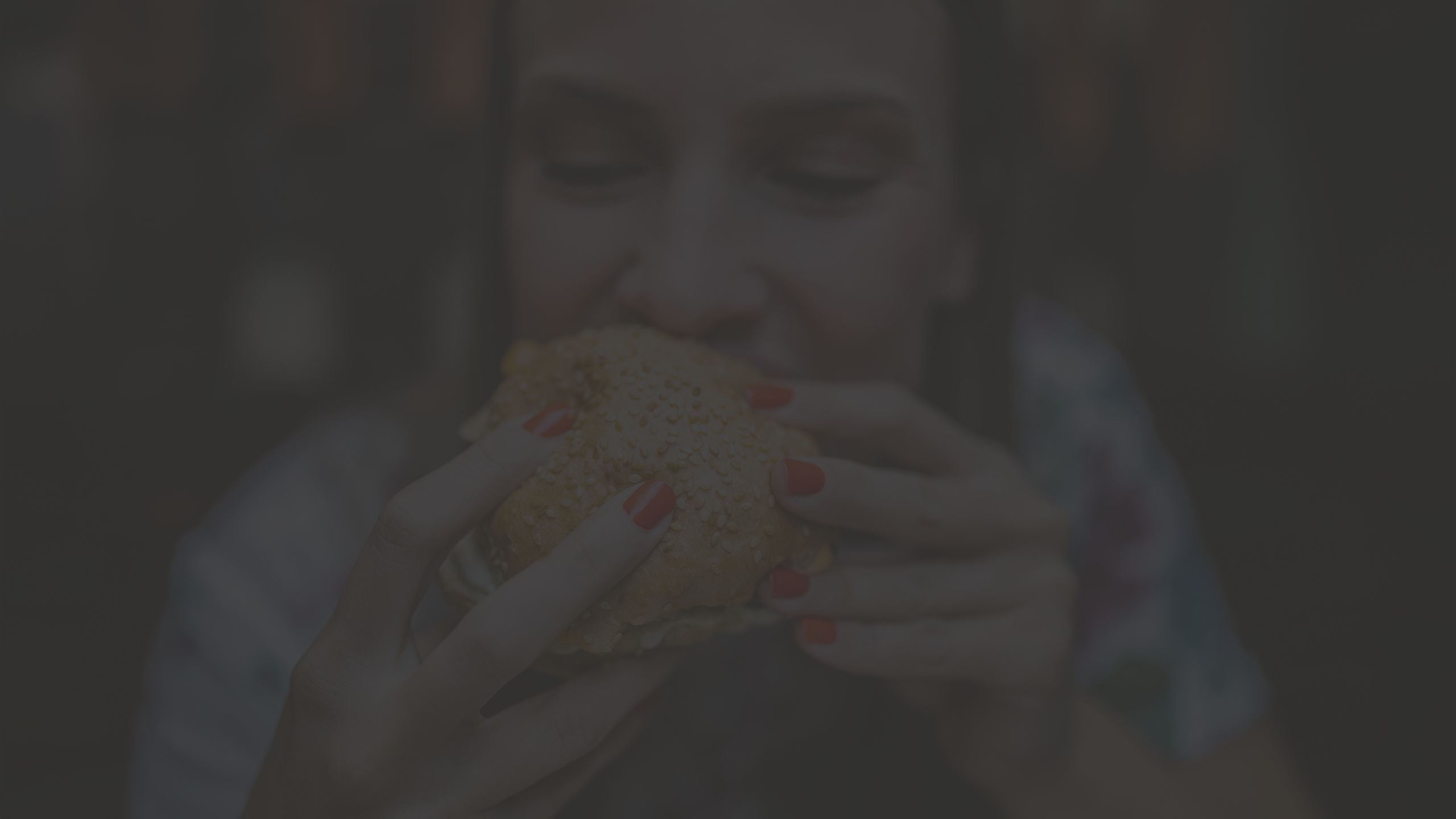 Woman eating a cheeseburger