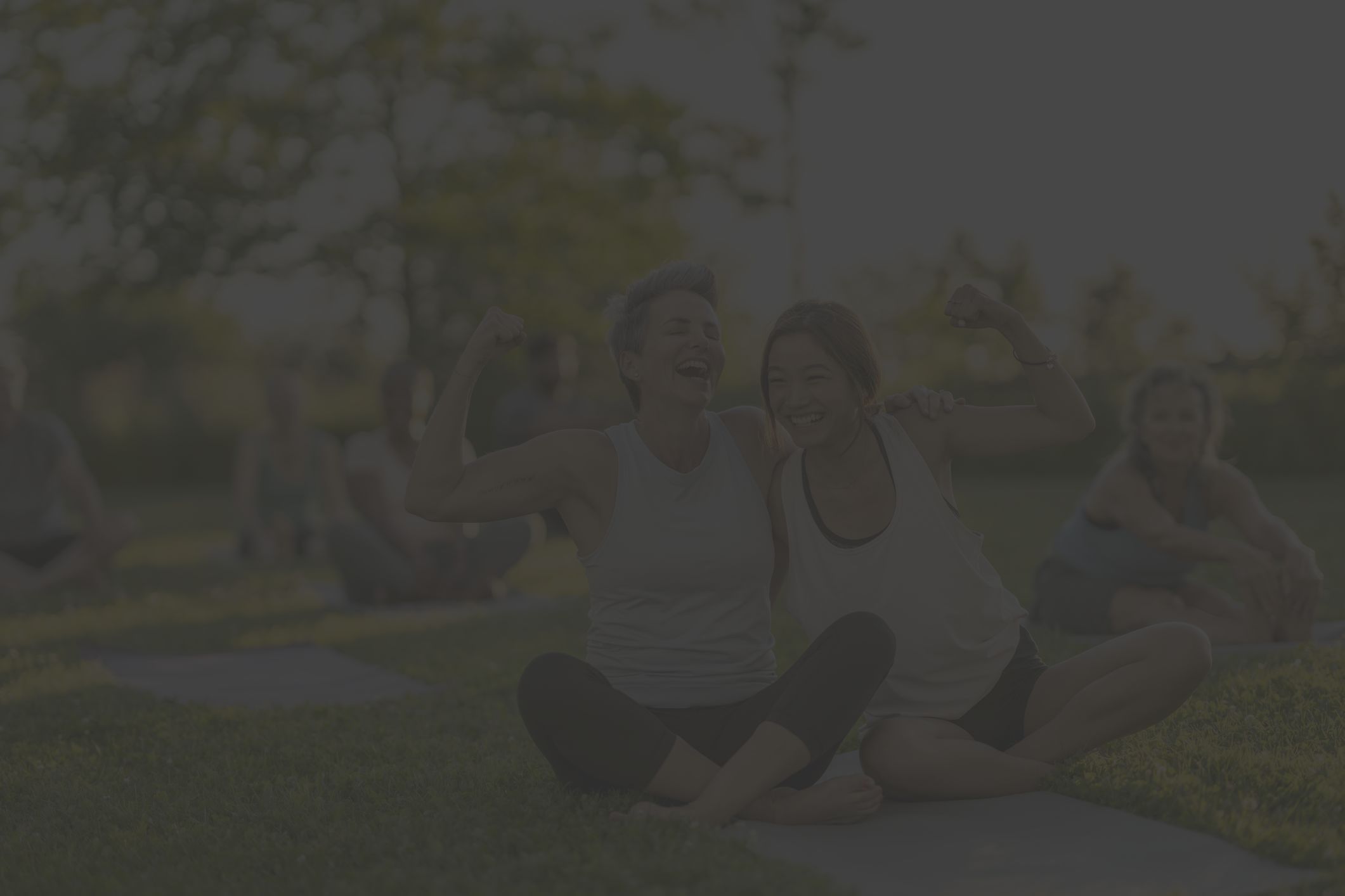 an older white woman and younger Asian woman celebrate after doing a yoga class