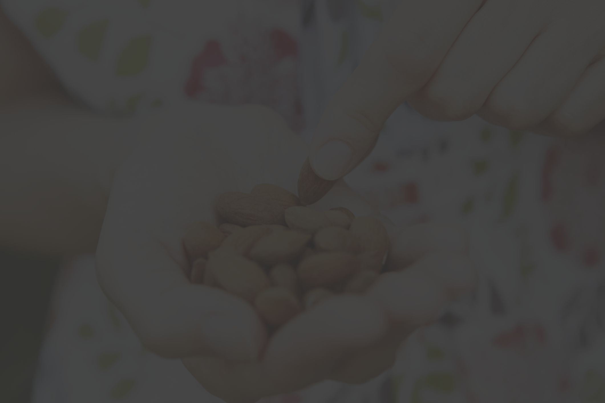 closeup of woman's hands holding almonds