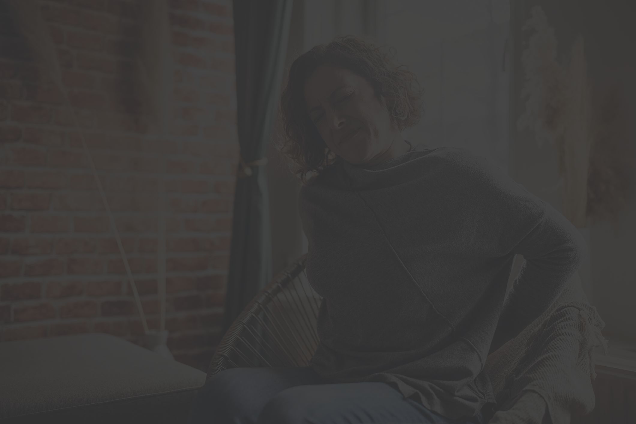 woman with aching back at home