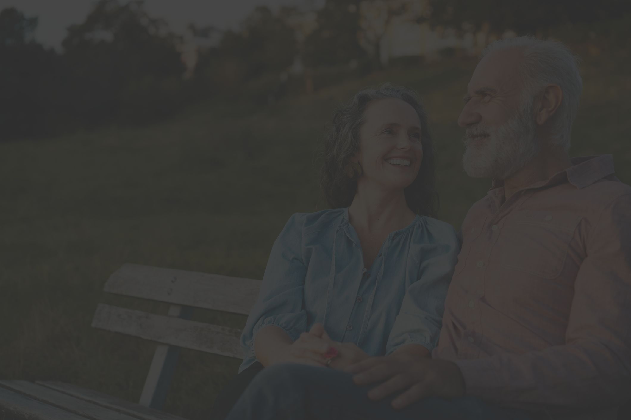 happy mature couple sitting outdoors
