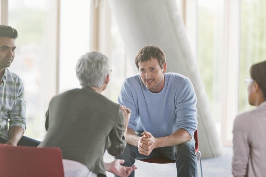 Small group of people sitting in a circle having a discussion