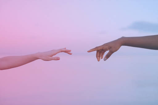 Two hands reaching for each other.