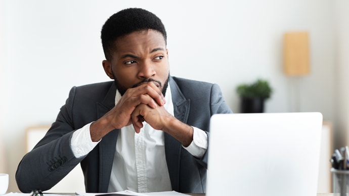 Man at his desk contemplating